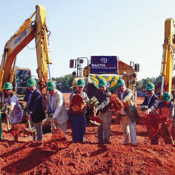 Representatives of Gatewood Schools, including Headmaster Jeff Decker, Assistant Headmaster Josh Ringer and Director of Development Marie Rainey, among others, joined several local officials in tossing a ceremonial shovelful of dirt for the official groundbreaking of Gatewood’s new high school. IAN TOCHER/Staff