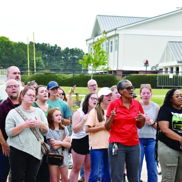 Attendees join in song during a prayer vigil held at Morgan County High School Sept. 10. (HANNAH BARRON/Staff)