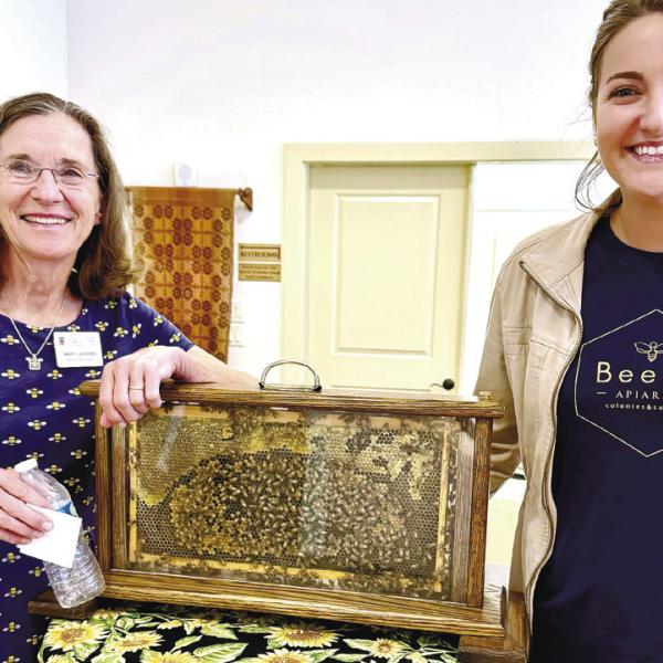BeeCo Apiaries’ Mary Lacksen (left) and her daughter-in-law Caroline Lacksen exhibit a live honeybee hive during their visit to Eatonton’s Old School History Museum last Sunday. CONTRIBUTED