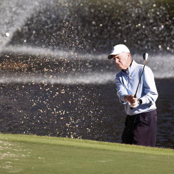 Doug Denholm hits a shot out of the bunker onto the green. LEIGH LOFGREN/Staff