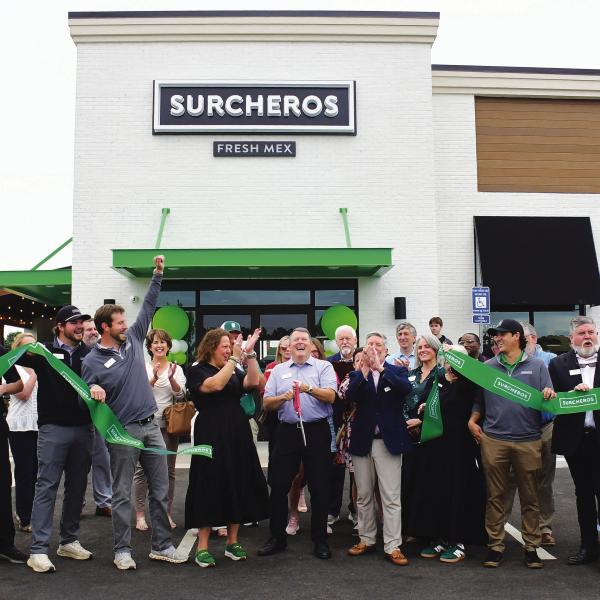 Kyle Cullars (center, holding scissors) completes the ribbon cutting for Surcheros, a new Tex-Mex restaurant alongside Hwy. 44, near the Thunder Pointe neighborhood on Lake Oconee. IAN TOCHER/Staff