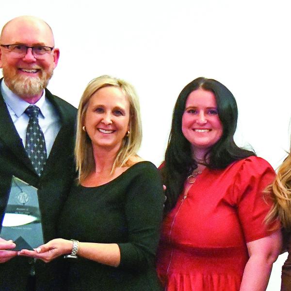 E-PCOC President Robbie King (far left) and Peoples Bank President Chuck Haley (far right) presented the 2026 Business of the Year Award to Keith Fitzgerald, founder and owner of ProSouth Services Electrical-Heating and Air, with his family. IAN TOCHER/Staff