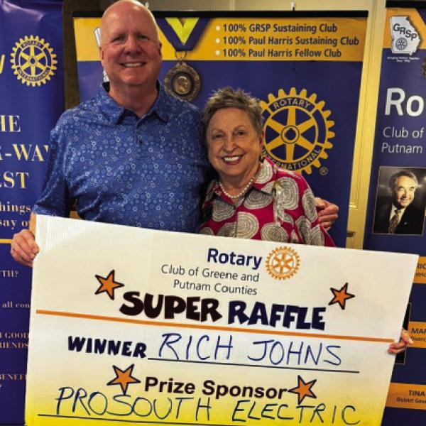 Rotary Raffle Week 38 winner Rich Johns accepted from Rotarian Micki Tanner his prize of a $300 Home Depot gift card, sponsored by ProSouth Electric. CONTRIBUTED