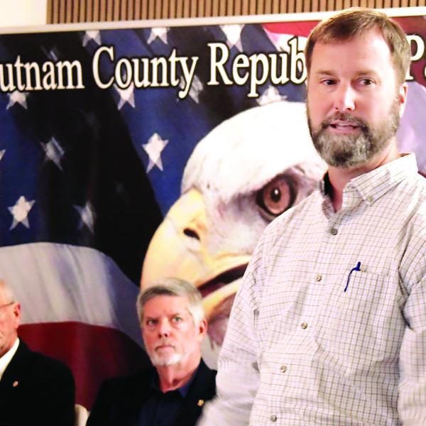 Steve Hersey (left) and E-P Chamber President Robbie King look on as Lenwood Pickens make a point to the audience during last Tuesday’s candidates’ debate. IAN TOCHER/Staff