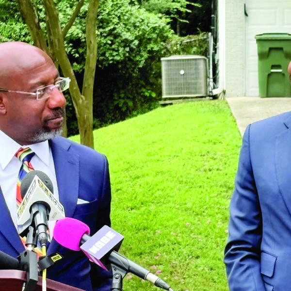 U.S. Sen. Raphael Warnock and Atlanta Mayor Andre Dickens, both Democrats, describe the impact of the bipartisan federal 21st Century ROAD to Housing Act while standing in Adamsville Drive in Southwest Atlanta on July 13. TY TAGAMI/Capitol Beat