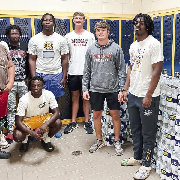 Members of the Morgan County High School Quarterback Club deliver water to Warren County. (CONTRIBUTED)