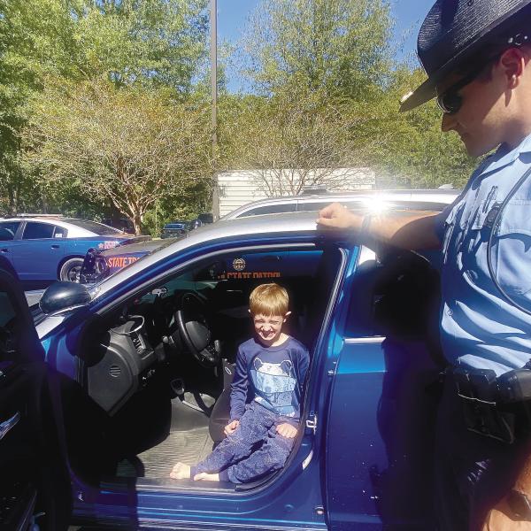 Christian Fuller, 8 years old, of Greensboro, checks out a few of the Georgia State Trooper vehicles. MAUREEN STRATTON/Staff