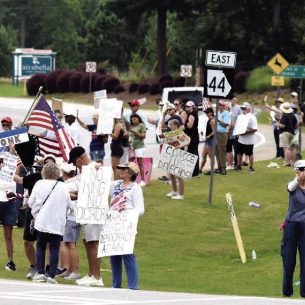 The No Kings rally held at the intersection of Lake Oconee Parkway and Linger Longer Road attracted people from six counties, many carrying signs expressing opposition to President Trump’s policies. T. MICHAEL STONE/Staff