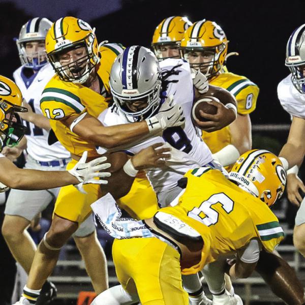 Brady Haley (5), Sean Bennett (12), and Drew Love (6) tackle a TCS ball carrier. TREY NORRIS/Staff