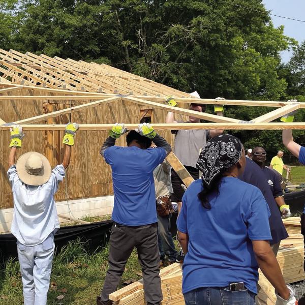Georgia-Pacific Madison Plywood employees install roof trusses. CONTRIBUTED