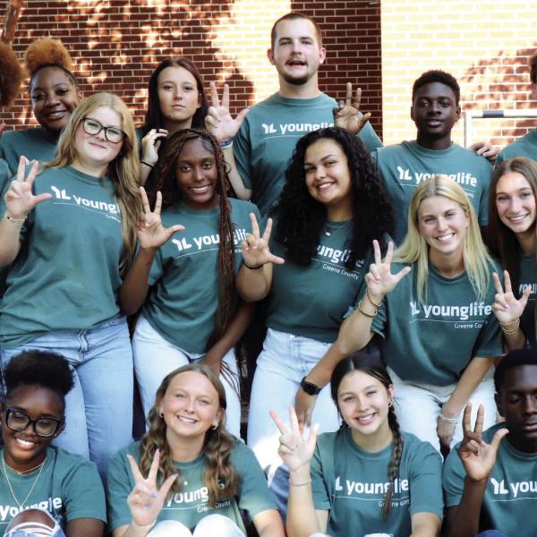 Greene County Young Life members hold up three fingers each to represent the “Three L’s of Discipling” within the organization’s ministry, including the Person of Christ, the Work of Christ, and the Invitation of Christ. CONTRIBUTED