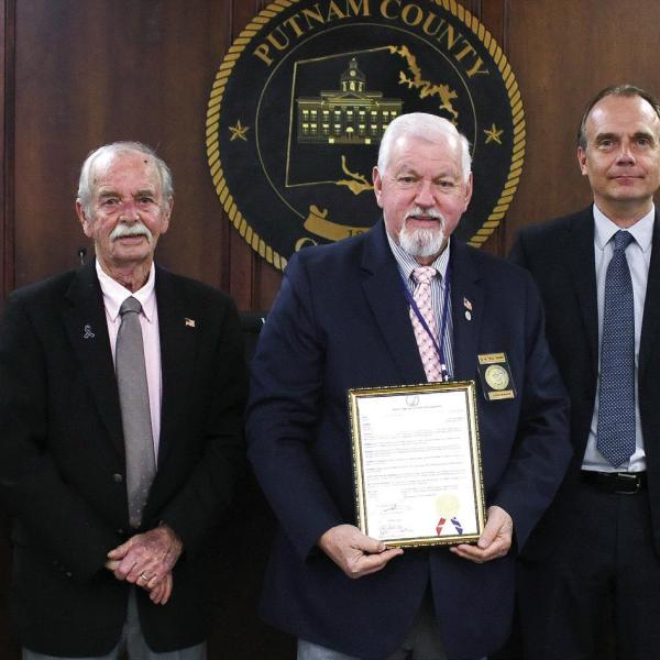 Putnam County Commission Chairman Bill Sharp holds a proclamation regarding Operation Green Light Putnam County, which encourages local citizens from Nov. 4-11, to “recognize the importance of honoring all those who made immeasurable sacrifices to preserve freedom by displaying green lights in a window of their place of business or residence.” IAN TOCHER/Staff