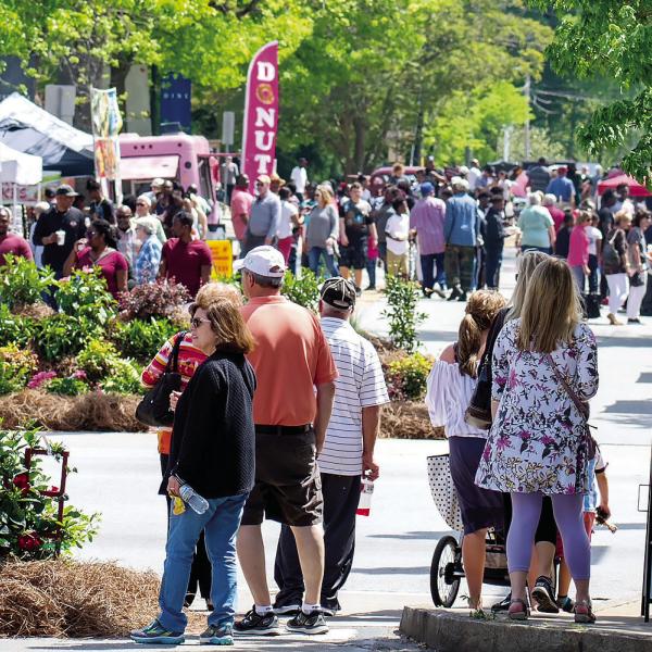 People walk the streets of downtown Greensboro while enjoying a previous, sunny Southland Jubilee. CONTRIBUTED