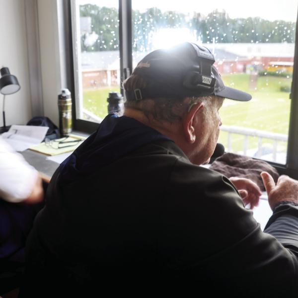 Putnam County assistant coach Charlie Winslette sits in the visiting coaches box at Morgan County High School in Madison, on Aug. 22. Winslette has been coaching high school football for 52 years. Abbey Cutrer/AJC