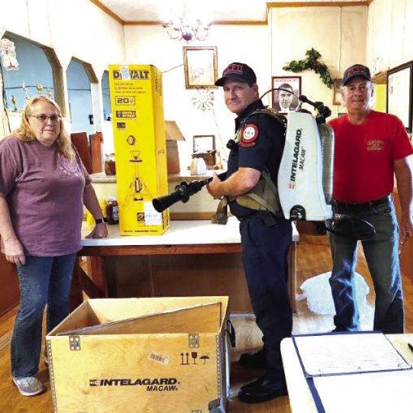 Last month, members of the Kinderhook Fire Association (KFA) donated a high-powered fire scene light and high-tech firefighting backpack to the Putnam County Fire Department. L-R: KFA Vice President Terea Jacobs with a PCFD firefighter and KFA President Elliott Perkins. CONTRIBUTED