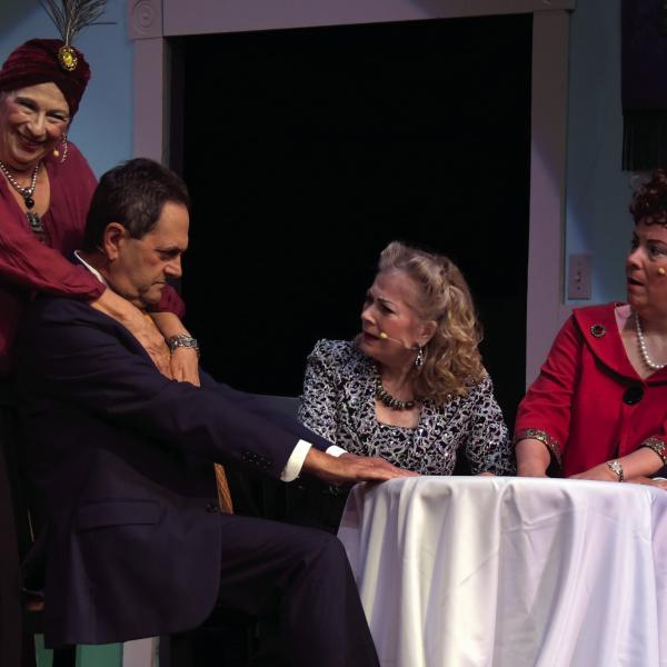 Veteran stage actor Lou Benjamin (second from left) drives the action in Blithe Spirit, as he contends with two – or more – spirited women at once.