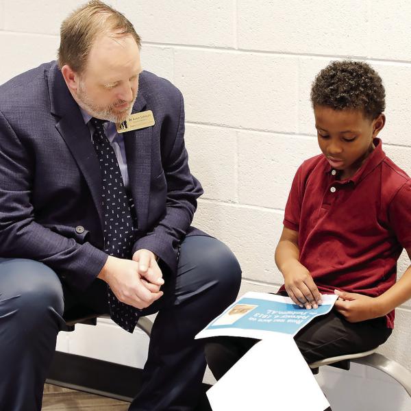 Schmuhl listens to a student’s Black History Month presentation. CONTRIBUTED