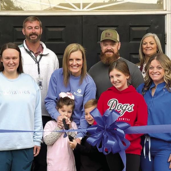 Whitney Williams (middle) celebrated opening her new private practice with a ribbon cutting ceremony, alongside family, employees and members of the Madison-Morgan Chamber of Commerce. CONTRIBUTED