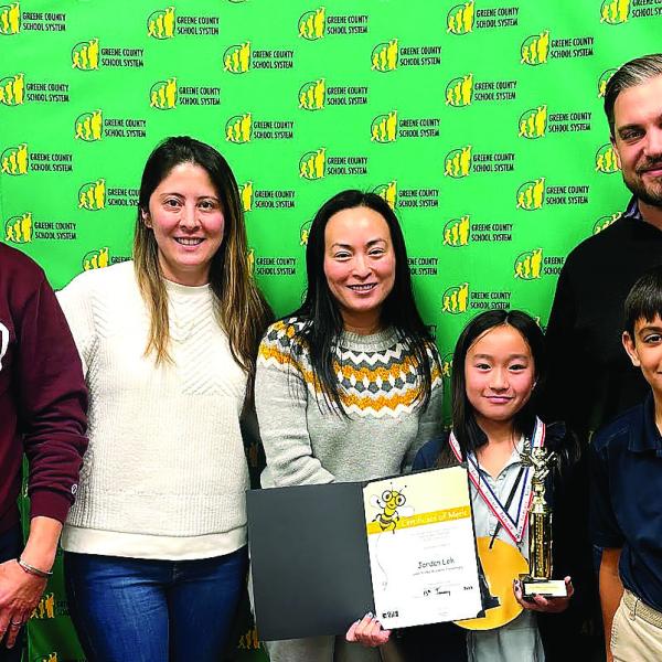 Lake Oconee Academy 4th-grade student Jordan Loh (third from right) advanced through 22 rounds of spelling competition last month to win the 2026 Greene County District Spelling Bee and advance to regional competition. CONTRIBUTED