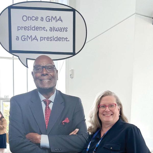City of Madison Planning and Development Director Monica Callaway poses with a poster of Madison Mayor and former GMA president Fred Perriman while attending the association’s 2026 conference. CONTRIBUTED