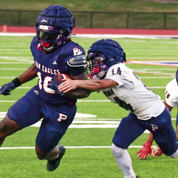 Putnam County running back Kumari Thomas tries to break a tackle during the team’s intrasquad scrimmage on May 15. IAN TOCHER/Staff