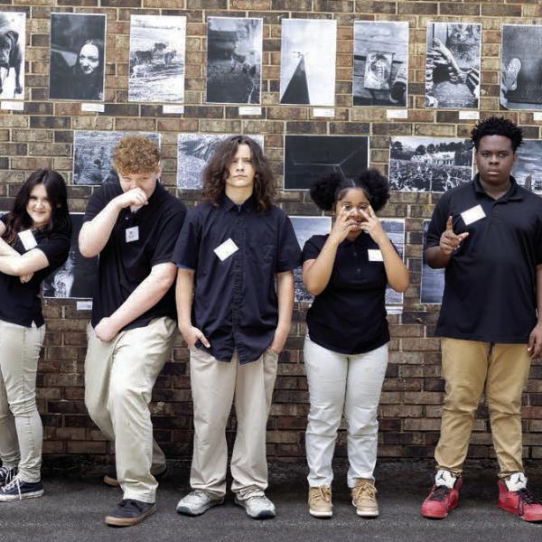 Participating students pose in front of their featured wall art. LEIGH LOFGREN/Staff