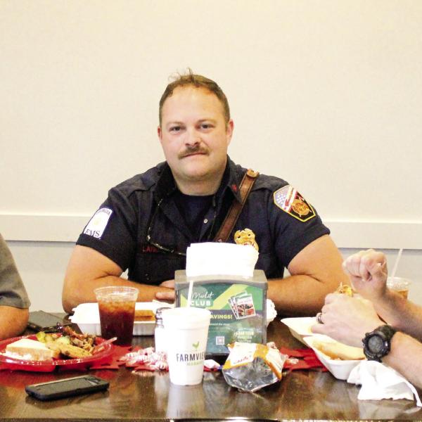 Local firefighters shared a little camaraderie while enjoying a complimentary barbeque lunch last Saturday at Farmview Market of Madison. SKYLA MORRIS/Staff