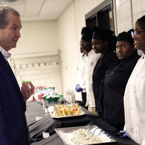 Gubernatorial candidate Rick Jackson engages with GCCA culinary students. CONTRIBUTED