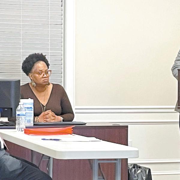 Putnam County School Superintendent Derick Austin (left) and Eatonton Mayor John Reid converse about the old elementary school building. LYNN HOBBS/Staff
