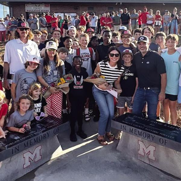 Community members gathered May 13 for the unveiling of benches dedicated in memory of middle school students Avett Jackson and Bennett Rabern who tragically lost their lives in an ATV accident in January. CONTRIBUTED