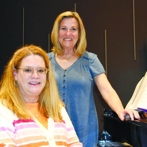 Music directors Amy Reber (seated) and Donna Valvo are considered the “heart and soul” of Greensboro’s Lake Country Chorus. CONTRIBUTED