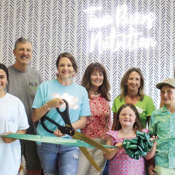 Taylor Wiggins cuts the ceremonial ribbon with the support of her employees, family and Chamber of Commerce staffers. (SKYLA MORRIS/Staff)
