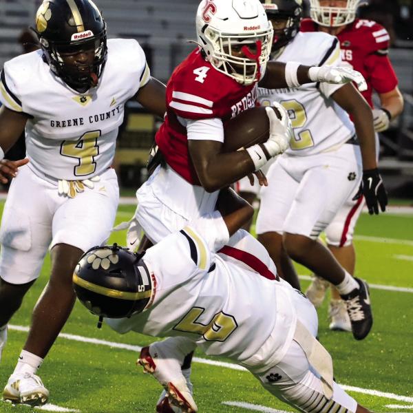 A host of Greene County defenders attempt to bring down Social Circle wide receiver T.J. Green (4). LANCE McCURLEY/Staff
