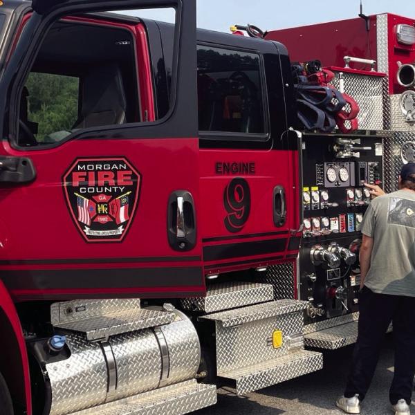Morgan County Battalion Chief Allen Hagler and firefighters Trenton Robinson and Russell Cook inspect a fire truck. CONTRIBUTED