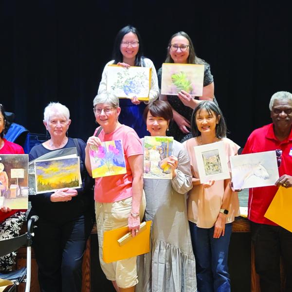 Artists with the artwork after the exchange. (CONTRIBUTED)