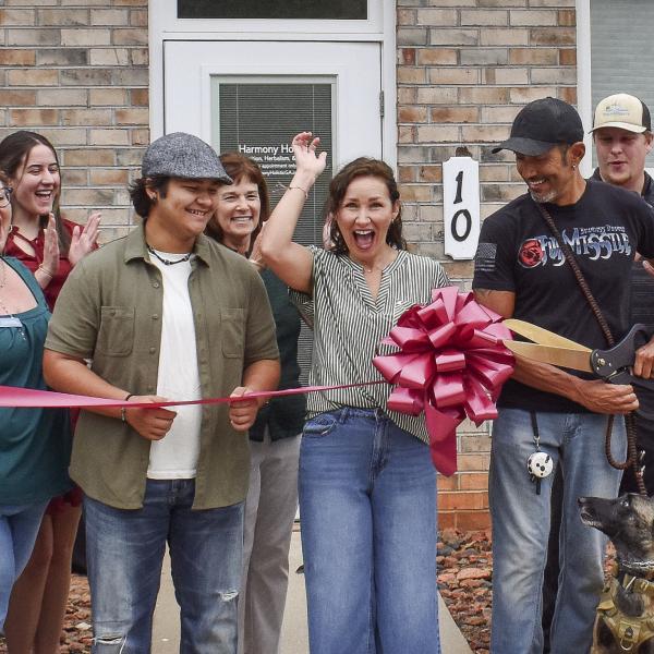 Kathi and Daryl Chandler (center) cut the ribbon last Wednesday to officially open Harmony Holistic, a wellness company that provides detox support and promotes the health advantages of eating beneficial foods. T. MICHAEL STONE/Staff