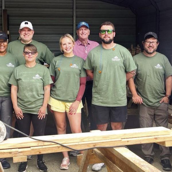 G-P employees help NHN build and deliver kids’ beds. CONTRIBUTED