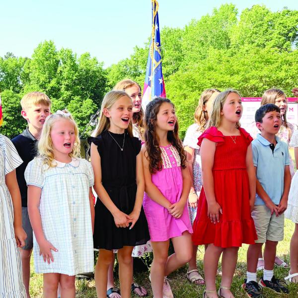 Morgan County Primary and Elementary School students sing the national anthem to open the Thursday morning groundbreaking ceremony. SKYLA MORRIS/Staff