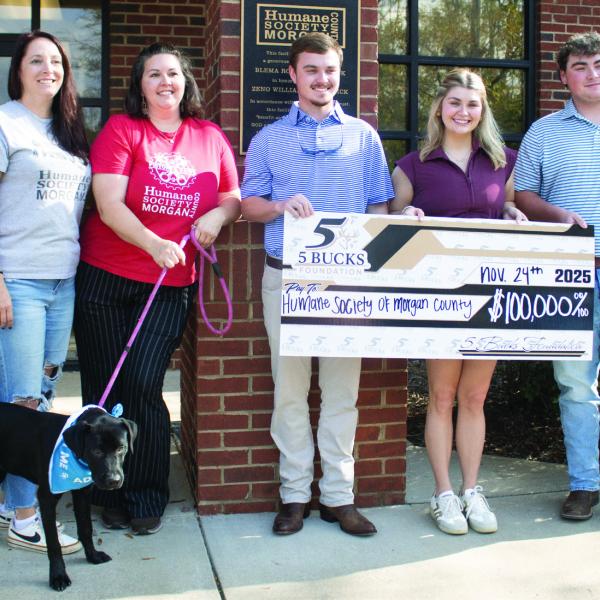 HSMC employees take a photo alongside Garrett, Gabrielle, and Griffin Smith as part of the $100,000 check presentation. CONTRIBUTED