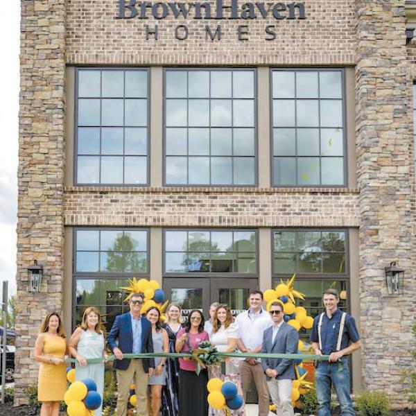 Brown Haven Homes staffers cut the ribbon alongside the Greene County Chamber of Commerce, to celebrate the site’s grand opening. T. MICHAEL STONE/Staff