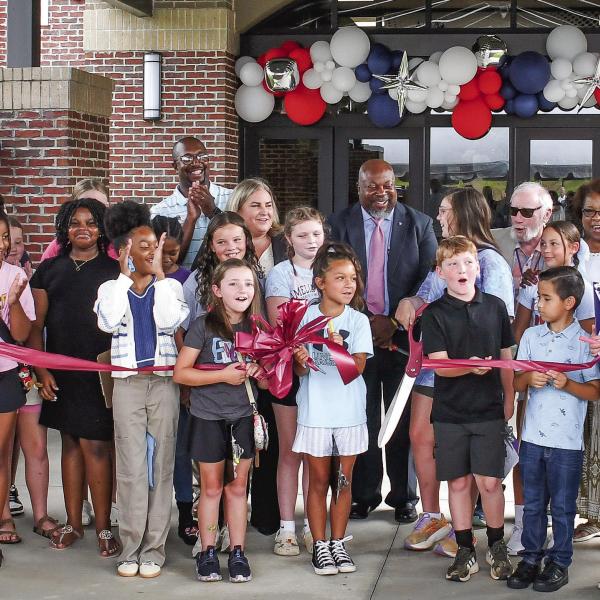 Along with several Putnam County Elementary School students at the ribbon cutting, Putnam County Board of Education Superintendent Derick Austin (center, pink tie) was joined by BOE board members Charles Trumbo (left, back row), BOE Chair Dr. Steve Weiner (sunglasses), and (l-r, back row,) Doris Clemons, Carol Ann Guthrie, and Rev. Simone Jones. PCES Principal Whitney Smith is standing to Austin’s right. IAN TOCHER/Staff