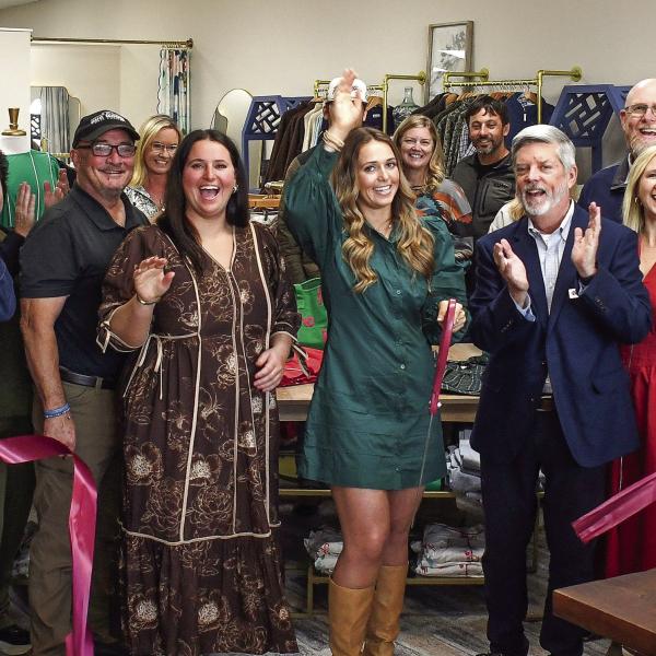 Sisters Megan and Mallory Fitzgerald (l-r, center) celebrate with friends and family at the official ribbon cutting Nov. 14, for their new Three Rays Boutique &amp; Head Spa at 646 Old Phoenix Rd., Eatonton. IAN TOCHER/Staff