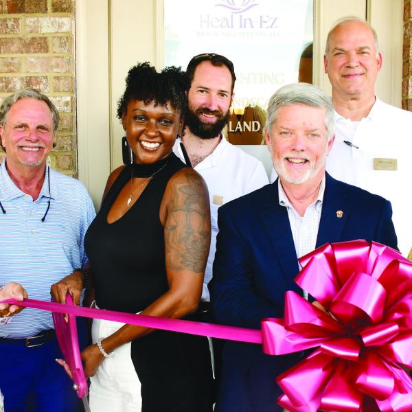 Latonya Taylor (third from left) prepares to cut the ribbon to officially open her Heal In-Ez Reiki &amp; Wellness Spa Aug. 5, in a ceremony hosted by the Eatonton-Putnam Chamber of Commerce. IAN TOCHER/Staff