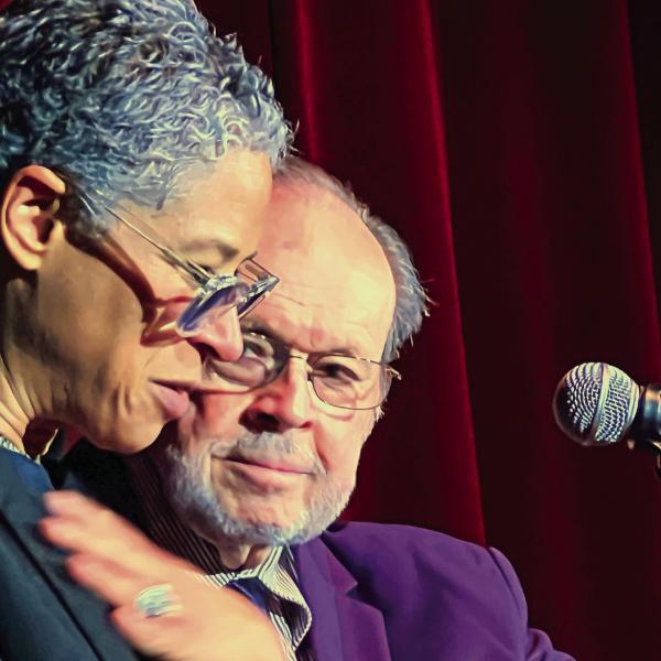 With Larry Moore by her side, Rebecca Walker is emotionally taken by seeing her father’s handwritten inscription inside the front cover of her mother Alice Walker’s first book, a collection of poems published in 1968. IAN TOCHER/Staff
