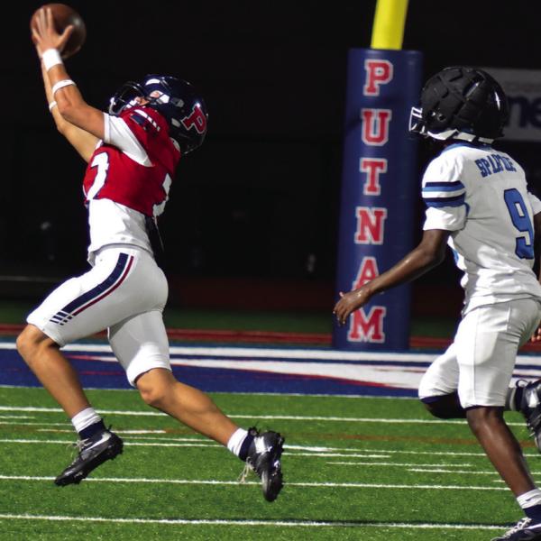Wideout Elijah Kelly is able to reach out and pull in a pass from quarterback Caleb Reeves in the rain last Friday night against the Glenn Hill Spartans. BRANDON PARK/Staff