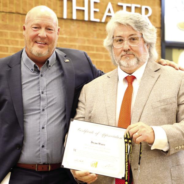 Superintendent Dr. Chris Houston (left) congratulates Dean Ware during the annual end-of-year breakfast. CONTRIBUTED
