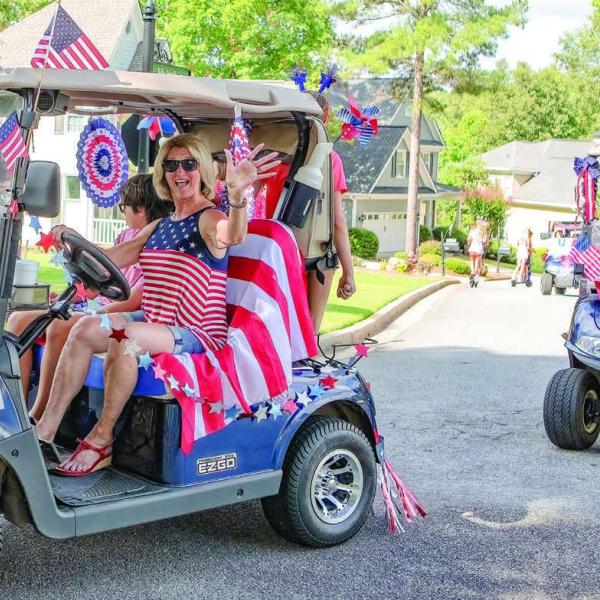 Harbor Club residents ride around celebrating the Fourth of July on their golf cars. (LEIGH LOFGREN/Staff)
