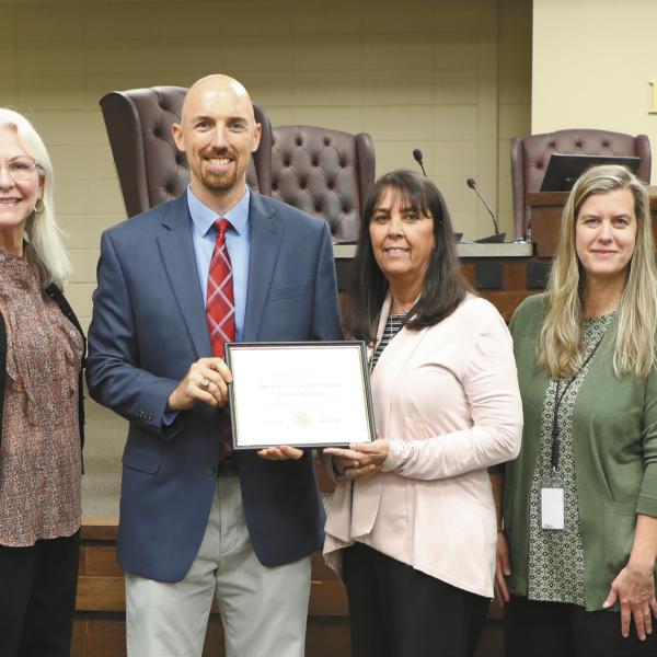 GDAA Auditor Luke Edwards (left center) presents the Award of Distinction for Excellent Financial Reporting to GCSS Chief Financial Officer Connie Wilkes and Assistant CFO Holly Dumdie (center right) joined by Board of Education members (l-r) Steve Kilgore, Dr. Perry Lee, Dr. Maggie Kjer, and Regina Gainer with Superintendent Dr. Chris Houston (far right). CONTRIBUTED
