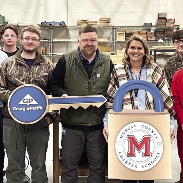 L-R: Daniel Whitten, Jack Morris, Dominic Baxter, Engineering Instructor Brian Johnson, Seth Mullins, Ben Jarrell, Georgia-Pacific Mill Manager Wesley Stone, CTAE Director Jennifer Butler, Tanner Somogy, Markus Mann, Michael Stewart, Principal Melanie Sigler, GP Human Resource Ashby Smith, Coach Greg Thompson, and Ag Mechanics Instructor Briana Stoops. CONTRIBUTED