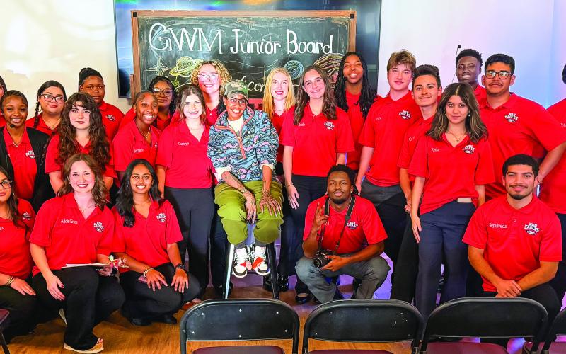 Surrounded by members of Putnam County High School’s Servant Leadership Class, Georgia author Nic Stone (center) relaxes at the Georgia Writers Museum after making a presentation last Friday night about her young adult book, Dear Martin. CONTRIBUTED